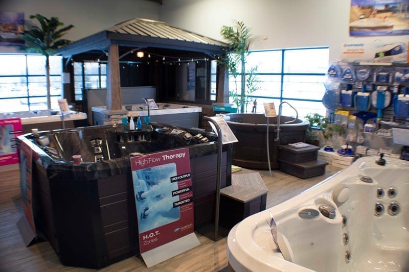 Hot tubs and furnishings on display in a showroom